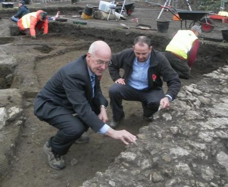 Andrew Hamilton (left) inspects the excavation with project director Dr David Gr