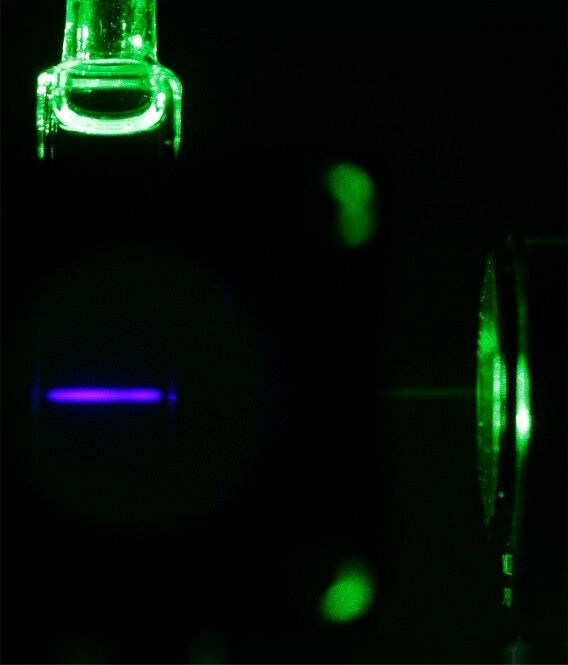 Green-to-blue light upconversion in a solution with a molecular ruby