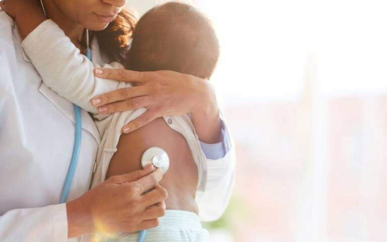 Baby with a doctor - AnnaStills �on iStock