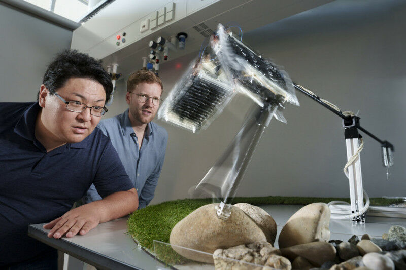 Toshihiko Fukushima (left) and Thomas Buchner (right) observe how the robot leg
