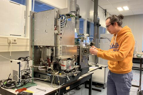 Researcher Victor Yin in front of the modified mass spectrometer used to break t