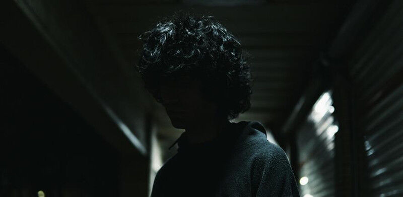 A man standing in a dark hallway with his hands in his pockets Credit: Mojtaba H