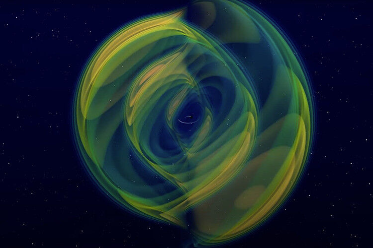 A still image from a numerical simulation of two black holes inspiraling and mer