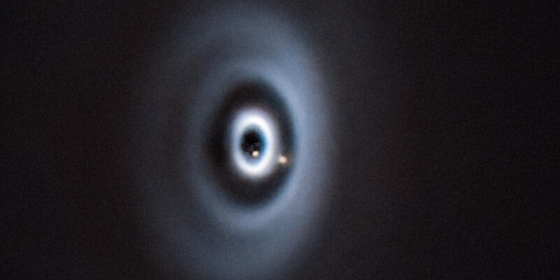 Astronomy & Space - This is roughly what the formation of the Earth in our solar system might have looked like. The birth of two planets (light brown dots) in a protoplanetary disc around the young star WISPIT 2. (Image: Astronomy & Space