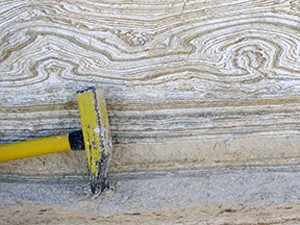 A section of exposed sediments along the shoreline of the Dead Sea exposes layer