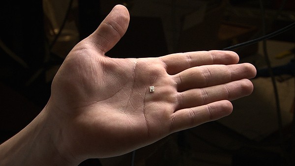 The current prototype chip, shown here resting on a hand, is only three millimet