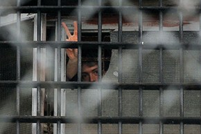 A man gestures from a window on 23 December at a prison in Minsk, where arrested