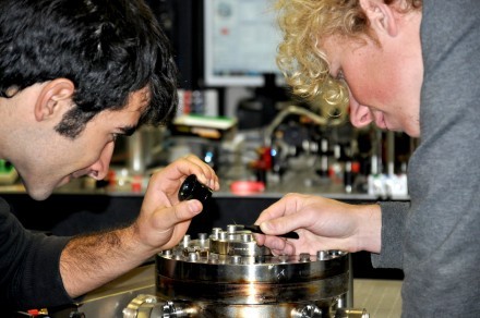 PhD students Giovanni Guccione (L) and Harry Slatyer examine their gold-coated s