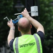 Worker attaching a sensor to a street lamp in South Kensington