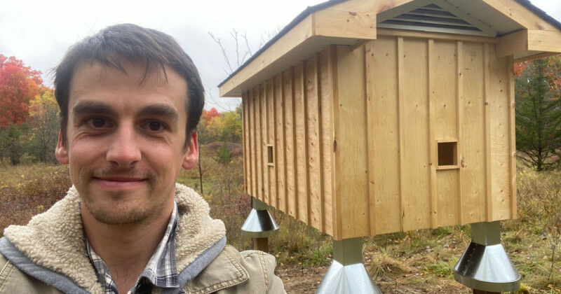 Brendon Samuels, PhD candidate in biology, with the barn swallow structure on th