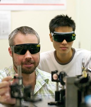 Professor Ben Eggleton (left) with recent graduate, Joe Mok, in the CUDOS lab.