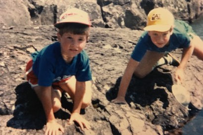 Noah (left) and his older brother, Seth, look at tadpoles on the north shore of 