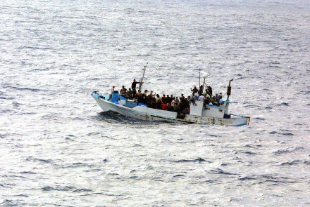 Refugees on a boat. (Photo by Defense Visual Information Center via Wikipedia)