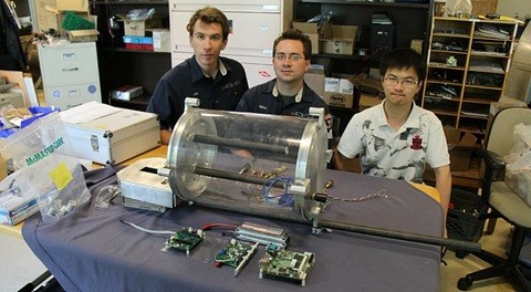 Team members Lee Wiseley, Mike Bujold and Xiaochuan Chen with the pressure hull 