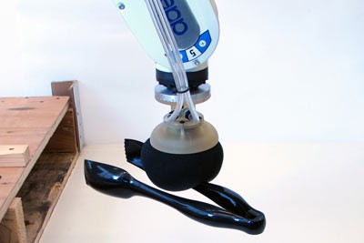 The universal jamming gripper picking up a pair of tongs. The trick is to decide