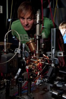 Dr Winfried Hensinger and the vacuum system, along with lasers and optics, which