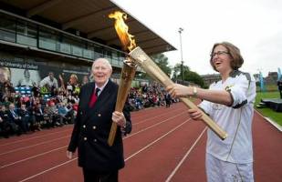 Sir Roger lights Olympic Torch at Iffley Road