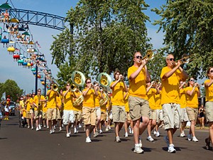 University president Eric Kaler, athletic director Joel Maturi and the Marching 