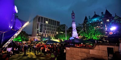 Bristo Square illuminated for festival nightlife.