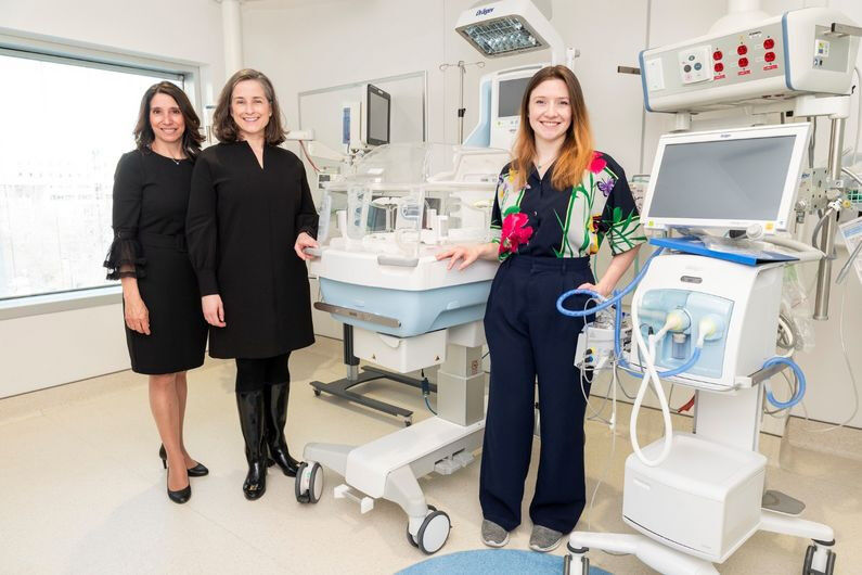 Marilyn Aita, Marjolaine Héon and Adèle Saives in front of an incubator used to