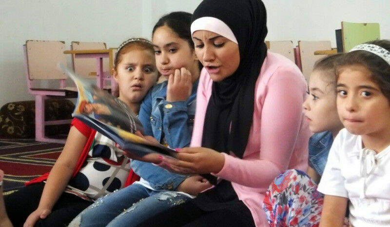 A We Love Reading ambassador reads aloud to children in a mosque in Karak, Jorda