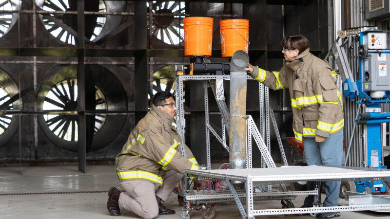 Vinny Gupta and Beth Weckman adjust some test equipment inside the Waterloo Fire