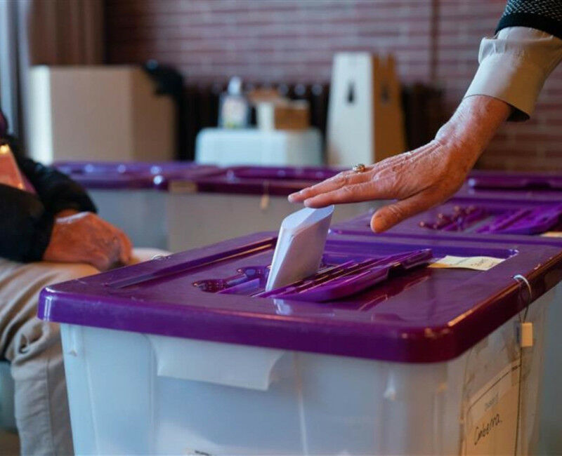 A woman casting her vote at an election.