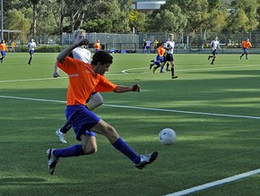 Players battle it out during a game of football on the FIFA accredited, new synt