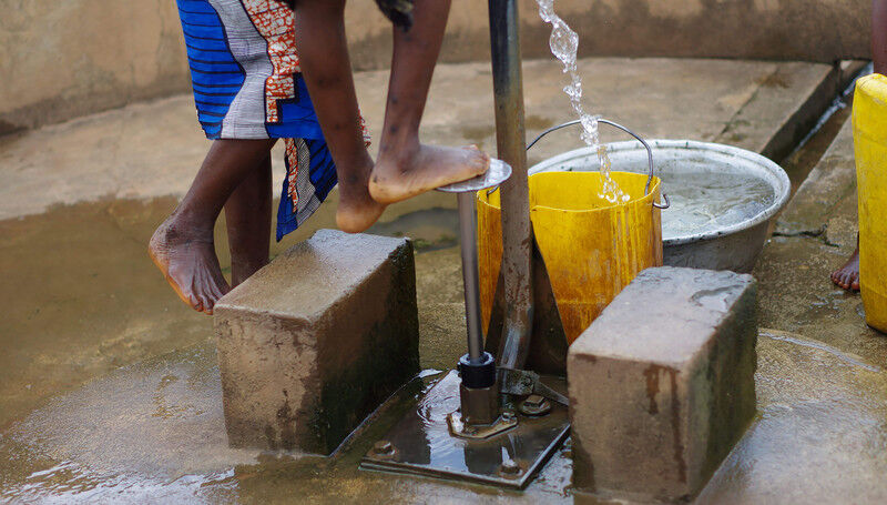 Children fetching water at foot pump in rural Togo (Photo: Jess MacArthur, 2013)